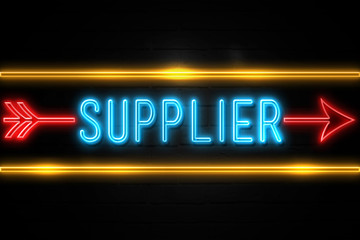 Obraz premium Supplier - fluorescent Neon Sign on brickwall Front view