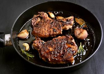 Grilled pork steak in frying pan