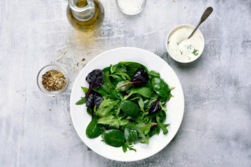 Spring salad with green leaves of spinach, arugul