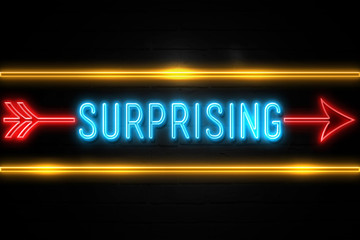 Obraz premium Surprising - fluorescent Neon Sign on brickwall Front view