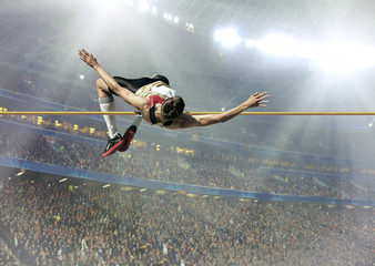 Fototapeta na wymiar Athlete in action of high jump.