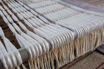 subtle silk weaving thread and yarn closeup. white cotton fiber