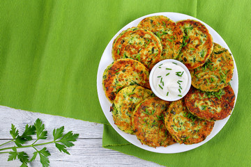 delicious zucchini fritters on white plate