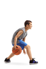 Profile shot of a boy dribbling a basketball