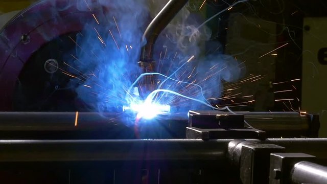 Metal iron laser argon welding robot in factory slow motion. Industrial robotics. Automation of work. Manufacture of refrigeration and ventilation industrial equipment and air conditioners.
