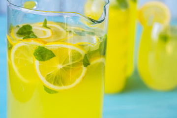 fresh lemonade with ice and mint on a blue background