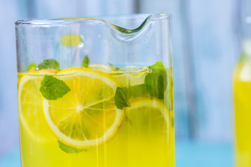 fresh lemonade with ice and mint on a blue background