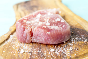 A fresh piece of tuna on a wooden board