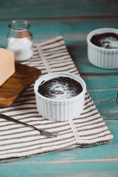 Homemade delicious chocolate muffine on wooden table.
