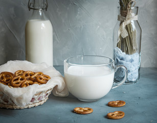 pretzels in a crib, glass of milk, bottle with milk and brunch of lavender