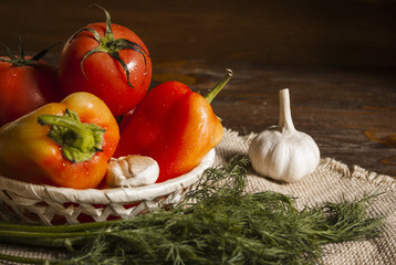 tomatoes, pepper, garlic and dill on a linen centerpiece
