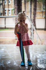 Small girl holding umbrella