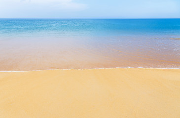 white soft wave on empty tropical beach and blue sea with blue sky background