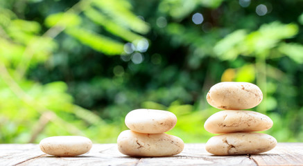 Three zen stones on old wood with nuture background