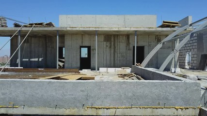 Aerial Shot Of Builders Team On Construction Site Discussing Plan Of Project With Architect And Contractor Using Blueprint On Digital Tablet - Powered by Adobe