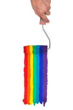 Hand Holding a paint Roller, painting Rainbow colors on an isolated White Background