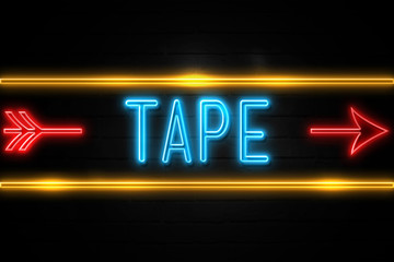 Naklejka premium Tape - fluorescent Neon Sign on brickwall Front view