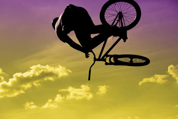 Bikers jumping on a ramp in the park