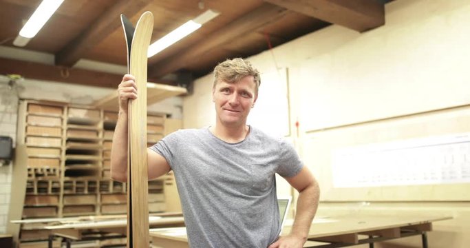 Portrait of owner in snowboard workshop