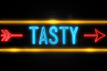 Tasty  - fluorescent Neon Sign on brickwall Front view