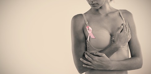 Young woman in pink bra with ribbon