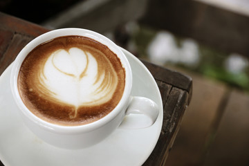 Hot coffee latte on wooden table morning.with space for your text