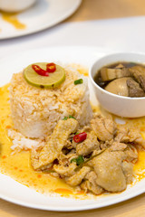 Chicken curry over steamed white rice serv with Egg curry in white dish, close up.