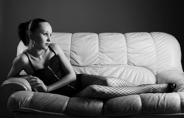 Portrait of sexy young model on sofa