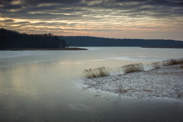 Sunset over frozen lake Kirsajty on Masuria, Poland