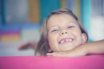 Little girl in playground. Caucasian girl looking at camera.