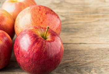 ripe juicy red apples on wooden background table