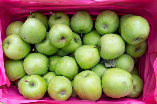 green apples in a wooden box