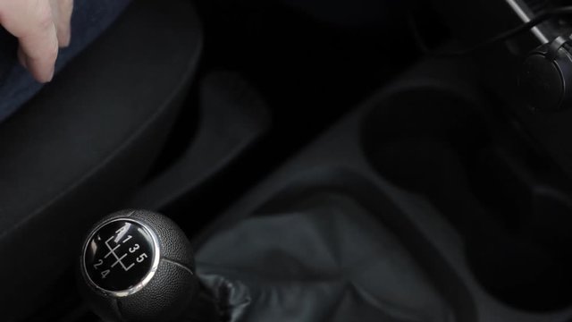 manual gear shift knob on a vehicle. hand of driver, driving car shifting gears