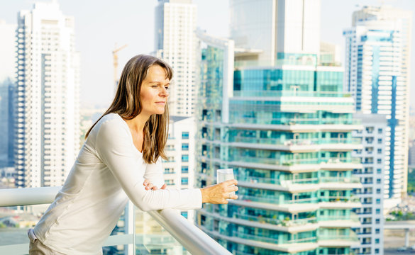 Woman On A Highrise Balcony