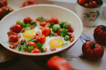 fried eggs with mixed vegetables in a frying pan
