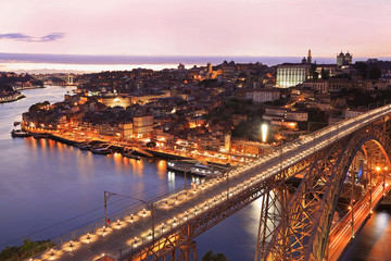 Fototapeta na wymiar Porto skyline and Douro River at dusk with Dom Luis I Bridge on the foreground, Portugal