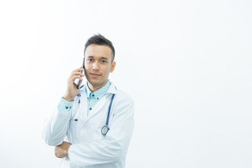 Fototapeta premium Smart medical man doctor smiling with stethoscope hand working with smart phone,isolated on white and copy space