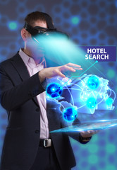 Business, Technology, Internet and network concept. Young businessman working in virtual reality glasses sees the inscription: Hotel search