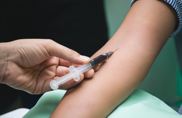 Nurse is collecting blood sample for testing