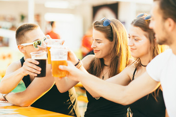 Fototapeta na wymiar Friends drinking beer at festival