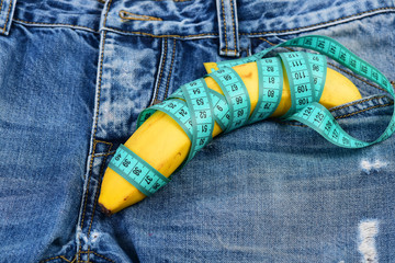 Health and male sexuality concept: banana wrapped with measure tape