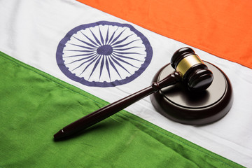 stock photo showing Indian low and jurisdiction - Indian national flag or tricolour with wooden...