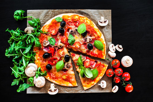 Pizza Margherita with cheese and basil leaf on dark background with fresh ingredients   for you to design and restaurant menu. Delicious Homemade Cheese  pizza.