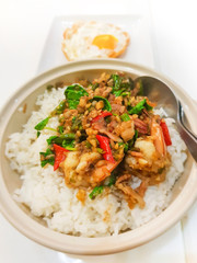 Fototapeta na wymiar Spicy fried shrimp with basil leaves on cooked rice
