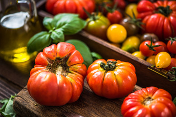Colorful variety of fresh tomatoes on wooden serving board