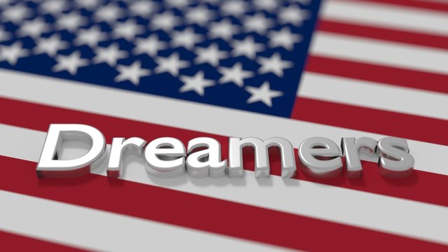 The word dreamers on an american flag daca immigration concept