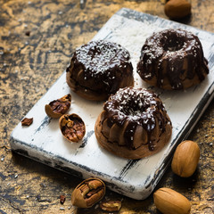 Chocolate muffins with pecans under chocolate ganache