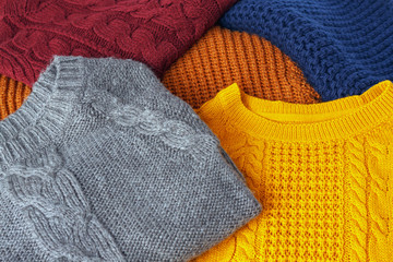 Concept knitted wool colorful warm sweaters closeup
