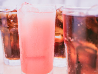 pink color from cool fruit juice with soft focus sparkling water (foreground and background) for summer and fresh