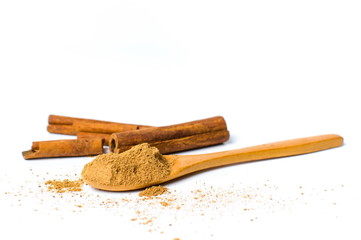 Cinnamon powder and sticks isolated
